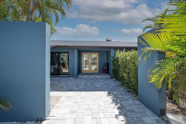 view of exterior entry featuring french doors