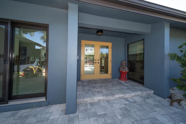 view of exterior entry featuring a patio and french doors