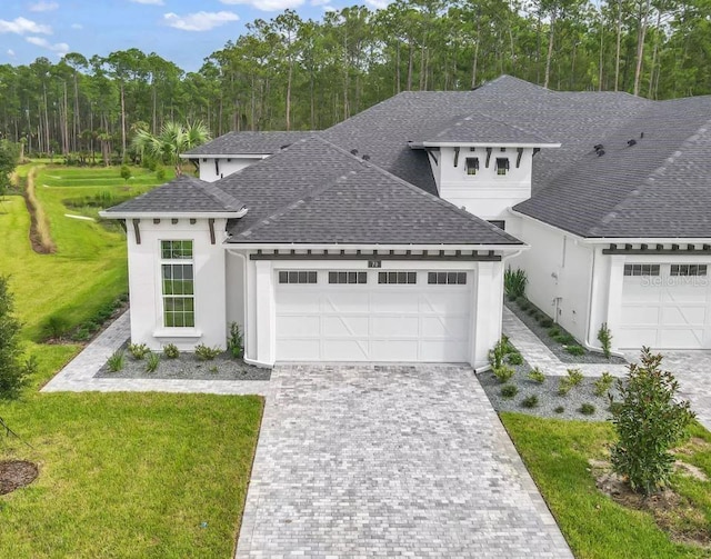 view of front of home featuring a garage and a front yard