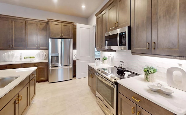 kitchen with stainless steel appliances and decorative backsplash