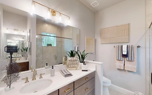 bathroom with vanity, toilet, and an enclosed shower