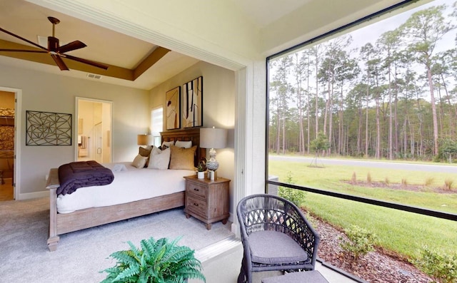 bedroom featuring multiple windows, ceiling fan, and ensuite bathroom