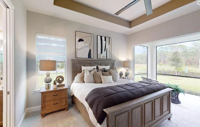 bedroom with light carpet, multiple windows, and ceiling fan