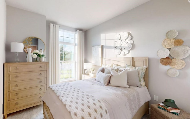 bedroom with lofted ceiling and carpet