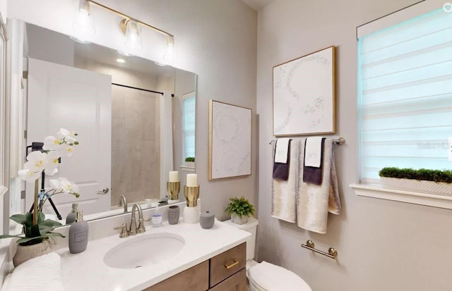 bathroom featuring plenty of natural light, vanity, toilet, and a shower with curtain