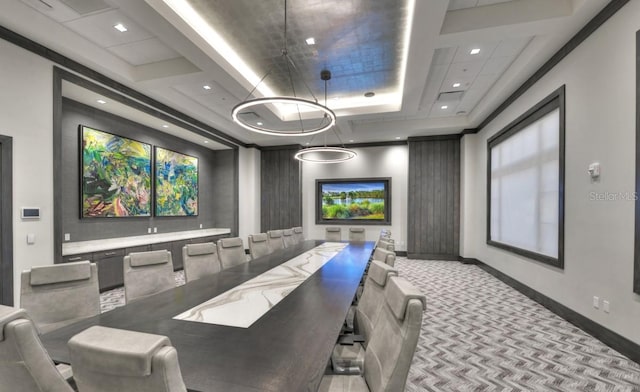 carpeted cinema room with a raised ceiling