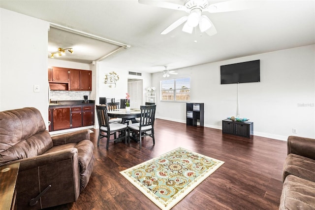 living room with dark wood-type flooring and ceiling fan