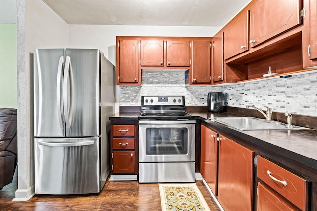 kitchen featuring tasteful backsplash, appliances with stainless steel finishes, sink, and dark hardwood / wood-style floors