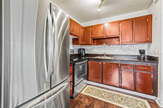 kitchen featuring stainless steel appliances, tasteful backsplash, sink, and dark hardwood / wood-style flooring