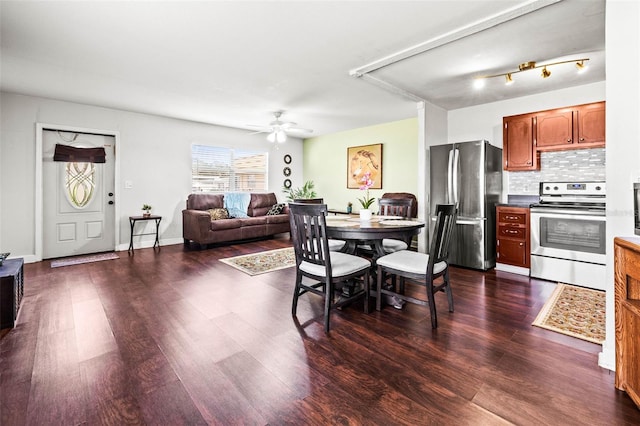 dining space with ceiling fan and dark hardwood / wood-style floors