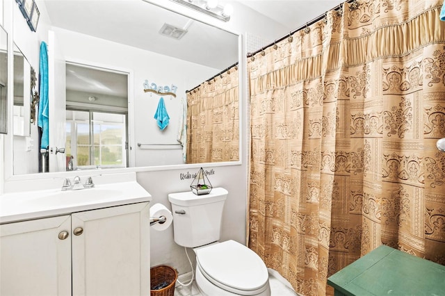 bathroom featuring toilet, a shower with curtain, and vanity