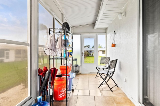 sunroom / solarium featuring lofted ceiling