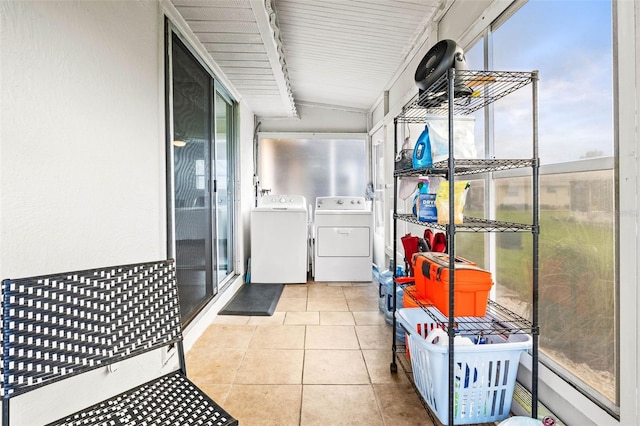 laundry area featuring washing machine and clothes dryer and light tile patterned floors