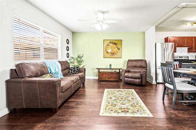 living room featuring ceiling fan and dark hardwood / wood-style flooring