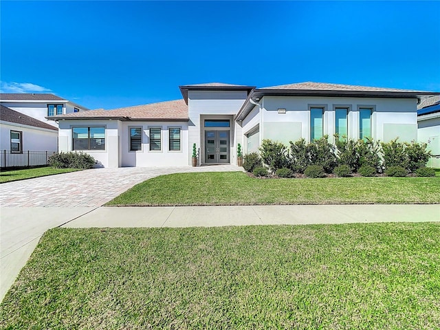 prairie-style house featuring a front lawn