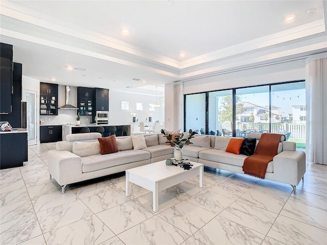 living room with a raised ceiling and a healthy amount of sunlight