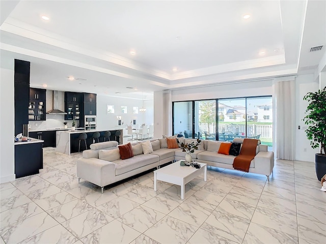 living room featuring a tray ceiling