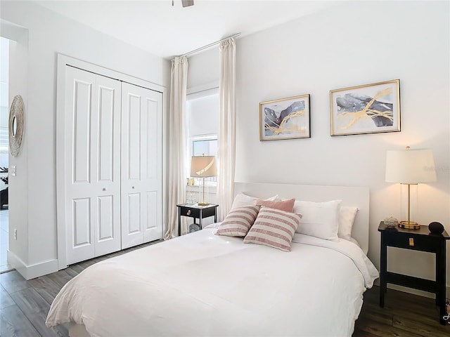 bedroom with a closet and dark hardwood / wood-style floors