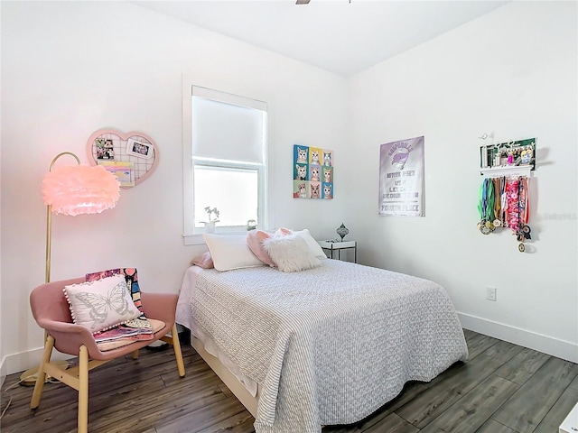 bedroom with dark hardwood / wood-style flooring and ceiling fan