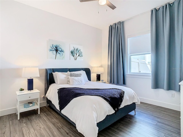 bedroom with ceiling fan and dark hardwood / wood-style floors