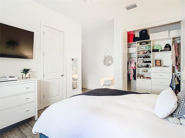 bedroom with dark hardwood / wood-style flooring