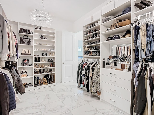 spacious closet featuring an inviting chandelier