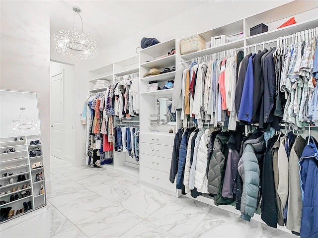 walk in closet with a chandelier