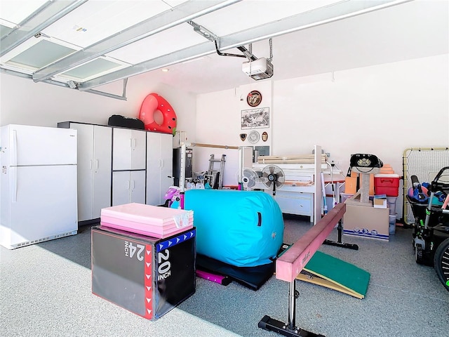 garage with white refrigerator and a garage door opener