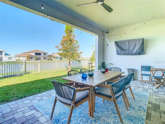 view of patio / terrace featuring ceiling fan and a water view