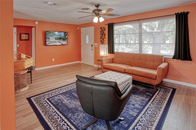 living room with hardwood / wood-style flooring and ceiling fan