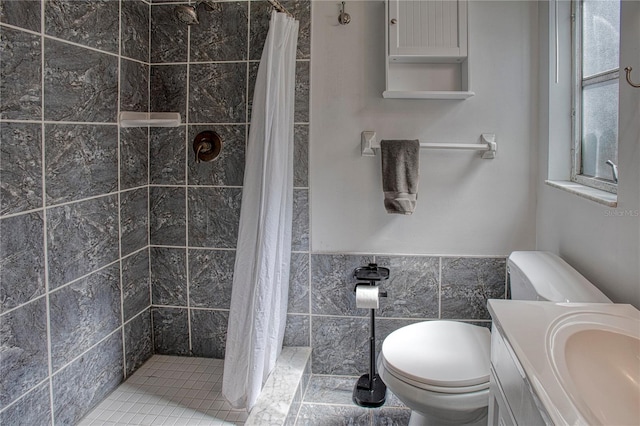 bathroom with vanity, tile patterned flooring, toilet, tile walls, and curtained shower