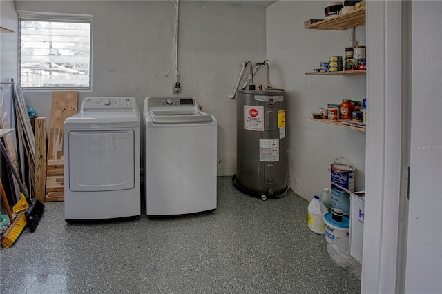 clothes washing area featuring washing machine and clothes dryer and water heater