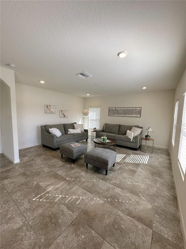 living room with a textured ceiling