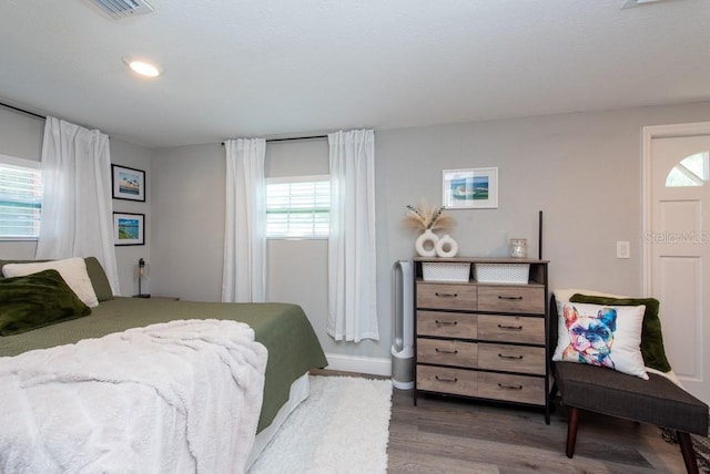 bedroom with dark wood-type flooring