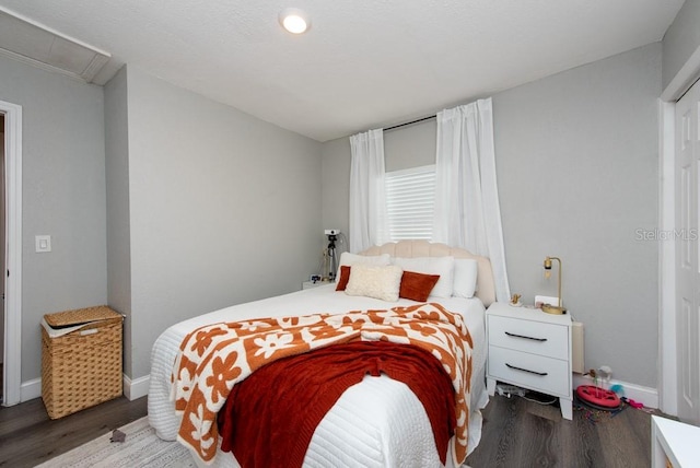 bedroom with dark wood-type flooring