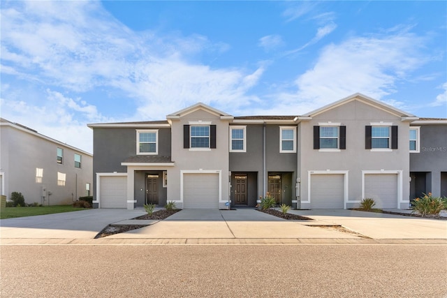 multi unit property featuring a garage