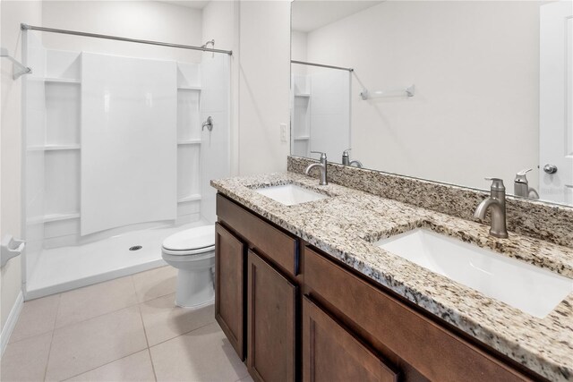 bathroom featuring vanity, toilet, walk in shower, and tile patterned flooring