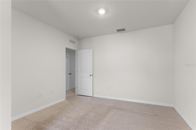 spare room with light carpet