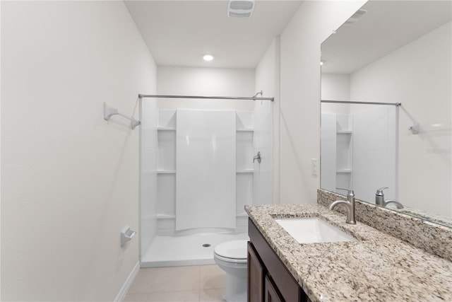 bathroom featuring toilet, walk in shower, vanity, and tile patterned flooring