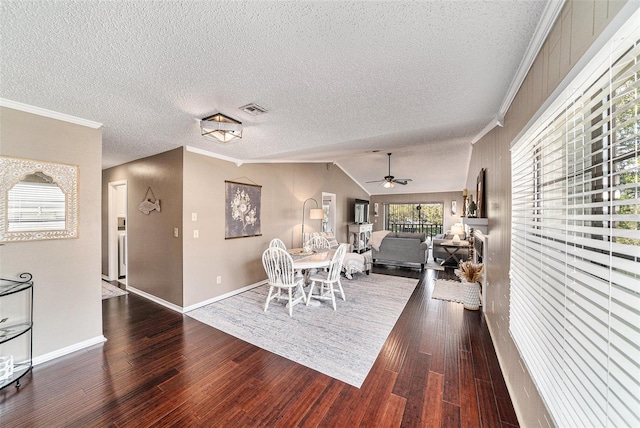 dining room featuring lofted ceiling, dark hardwood / wood-style floors, crown molding, a textured ceiling, and ceiling fan