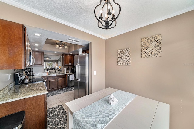 tiled dining room with crown molding, a textured ceiling, and ceiling fan with notable chandelier