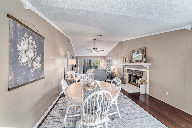 dining space with crown molding, dark hardwood / wood-style floors, ceiling fan, and vaulted ceiling