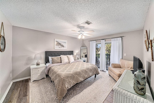 bedroom with access to outside, a textured ceiling, hardwood / wood-style flooring, and ceiling fan