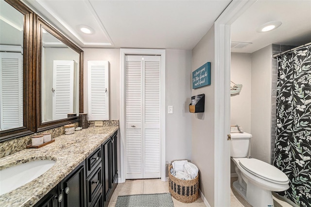 bathroom with vanity, toilet, and tile patterned flooring