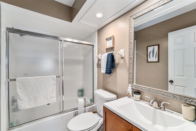 full bathroom with vanity, toilet, and bath / shower combo with glass door