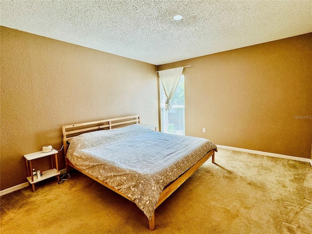 bedroom with carpet flooring and a textured ceiling