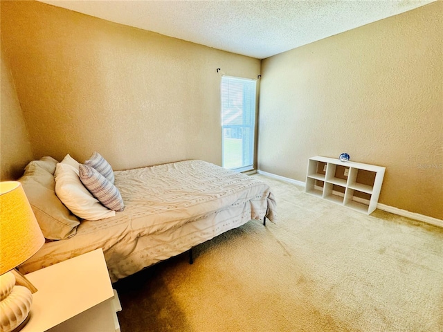 carpeted bedroom with a textured ceiling