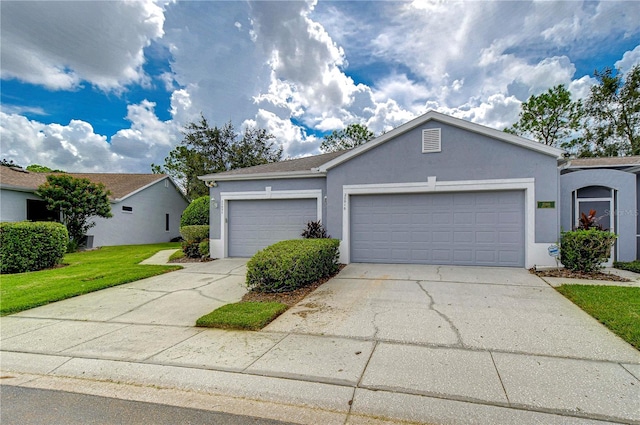 view of front of house with a front yard and a garage