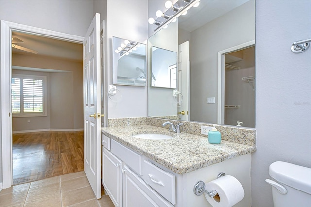 bathroom featuring vanity, toilet, and hardwood / wood-style floors