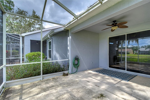 unfurnished sunroom with a healthy amount of sunlight and ceiling fan